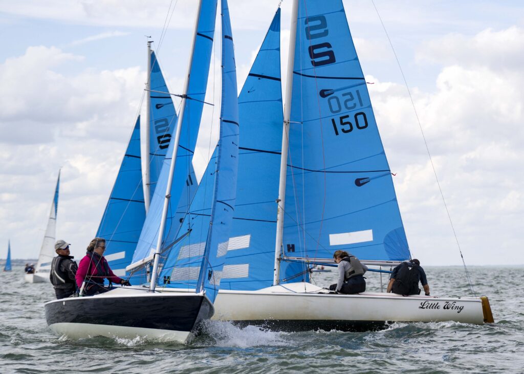 Blue jacket, sail number 154. Image 6